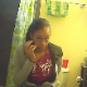 A black girl is seen peeing while sitting on a toilet and then wiping herself, dropping the toilet paper roll in the process. We are not sure if this is genuine voyeur because she appears to be looking at the camera.